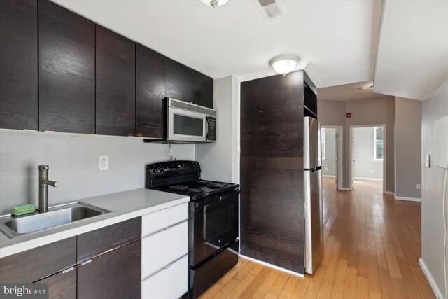 kitchen featuring light hardwood / wood-style floors, stainless steel appliances, and sink