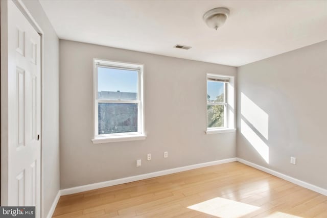 1716 N 18th St, Philadelphia, PA 19121 - unfurnished room featuring visible vents, a wealth of natural light, wood finished floors, and baseboards