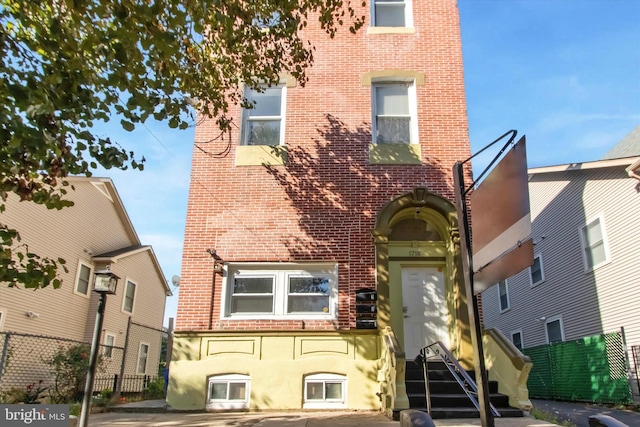 1716 N 18th St, Philadelphia, PA 19121 - view of front of home with fence and brick siding