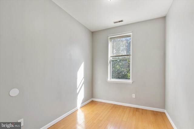 unfurnished room with hardwood / wood-style floors