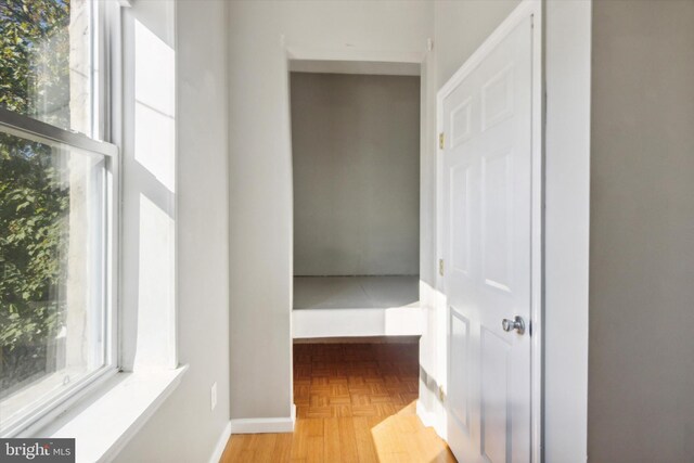 corridor with light parquet flooring