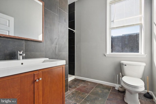1716 N 18th St, Philadelphia, PA 19121 - bathroom with stone finish flooring, baseboards, walk in shower, toilet, and vanity