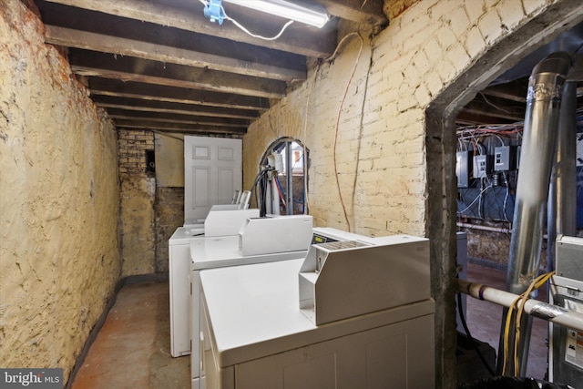 clothes washing area featuring separate washer and dryer