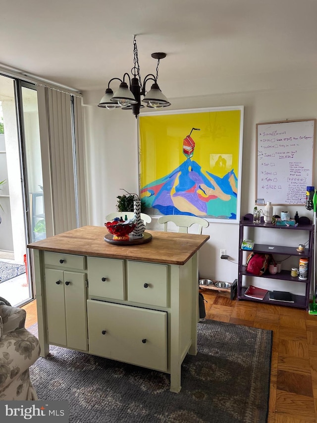 dining area with dark parquet flooring and a notable chandelier