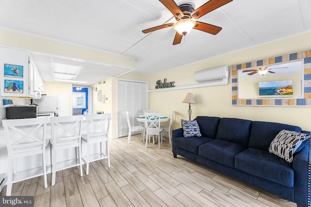 living room with ceiling fan, light hardwood / wood-style floors, and an AC wall unit