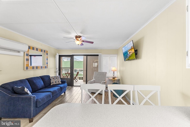 living room featuring hardwood / wood-style flooring, an AC wall unit, ornamental molding, ceiling fan, and french doors