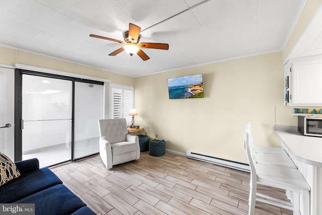 living room featuring a baseboard radiator, light wood-type flooring, ceiling fan, and crown molding