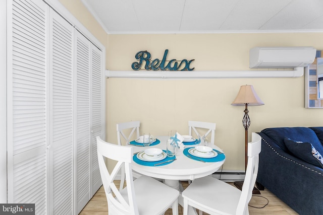 dining space featuring light hardwood / wood-style floors, crown molding, and a wall mounted air conditioner