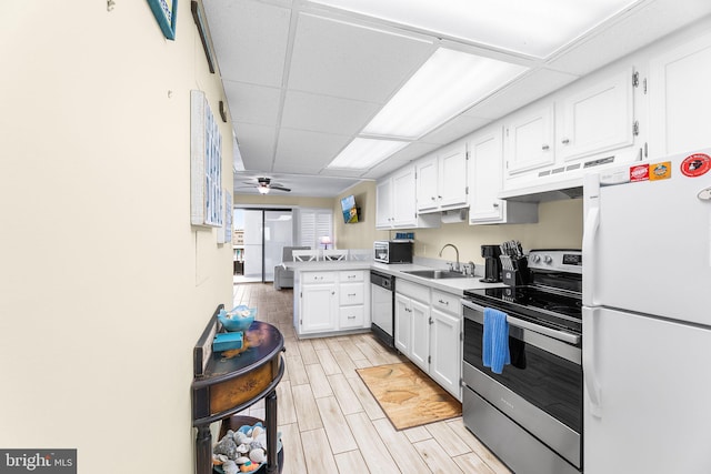 kitchen with dishwashing machine, white cabinets, white refrigerator, kitchen peninsula, and stainless steel electric range oven