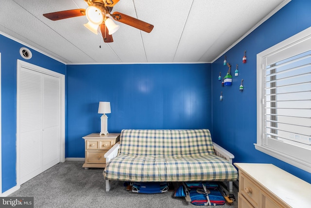 unfurnished bedroom with ceiling fan, a textured ceiling, a closet, multiple windows, and carpet floors