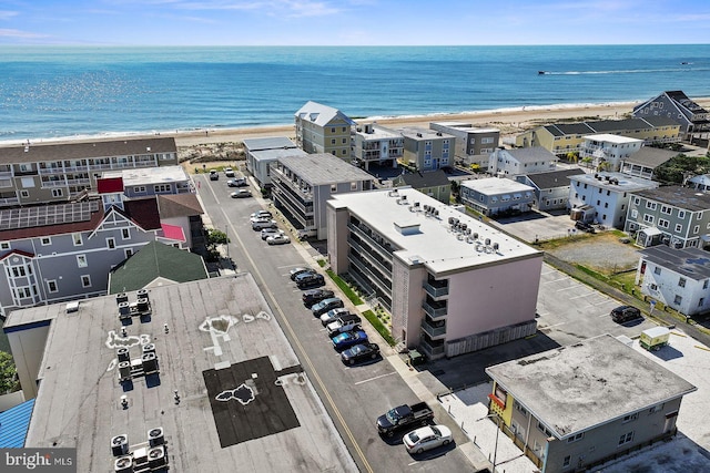 birds eye view of property with a view of the beach and a water view