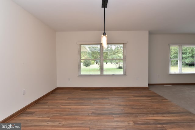 unfurnished room with dark hardwood / wood-style flooring