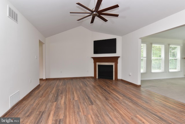 unfurnished living room with dark wood-type flooring, ceiling fan, and lofted ceiling