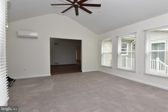 carpeted empty room featuring lofted ceiling, a wall mounted AC, a healthy amount of sunlight, and ceiling fan