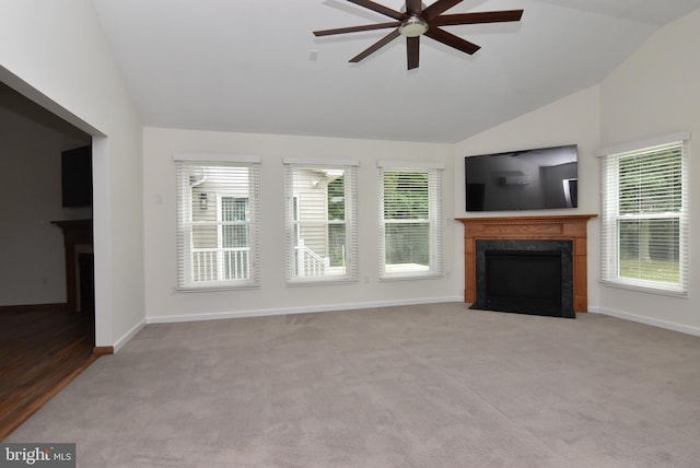 unfurnished living room with lofted ceiling, a healthy amount of sunlight, and a fireplace