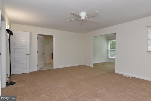 carpeted empty room with ceiling fan