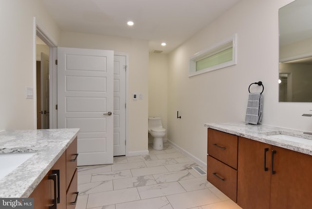 bathroom featuring toilet and vanity