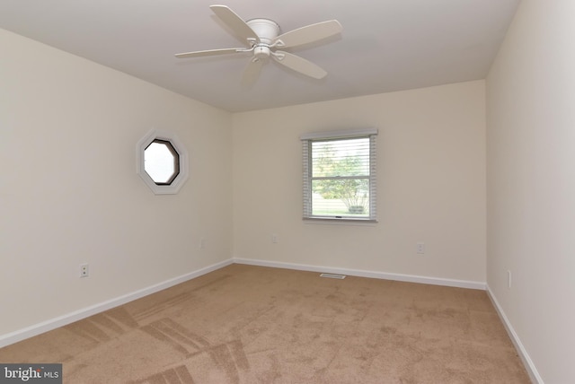 carpeted empty room with ceiling fan