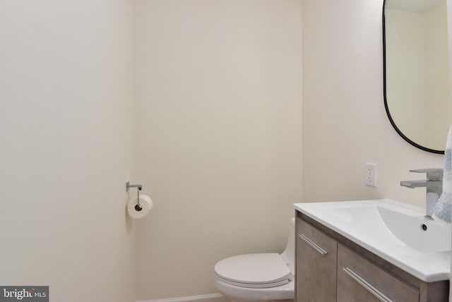 bathroom with toilet and vanity