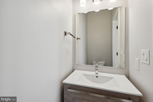 bathroom with toilet and vanity