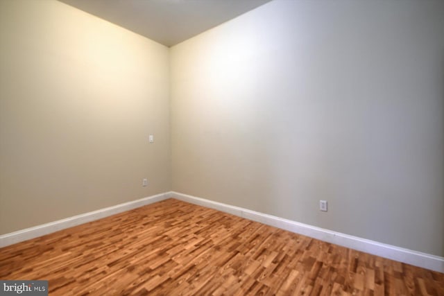 unfurnished room with hardwood / wood-style floors