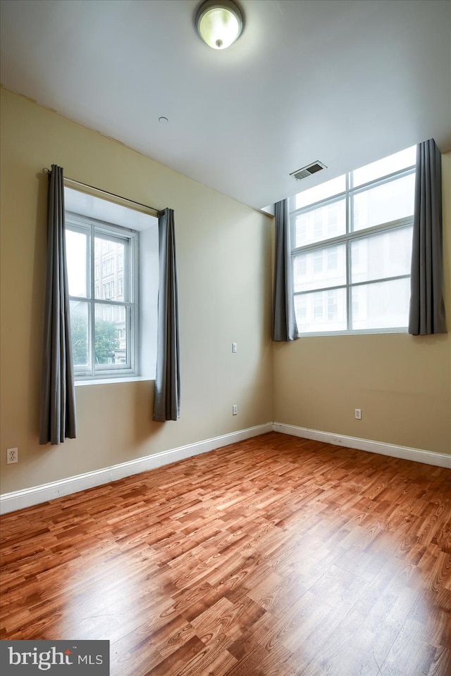 spare room with light wood-type flooring