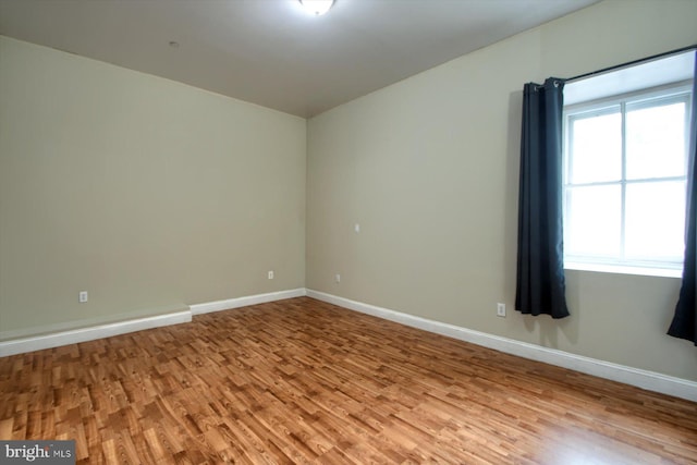 unfurnished room with light hardwood / wood-style floors