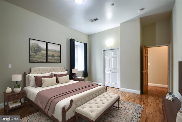 bedroom featuring hardwood / wood-style floors and a closet