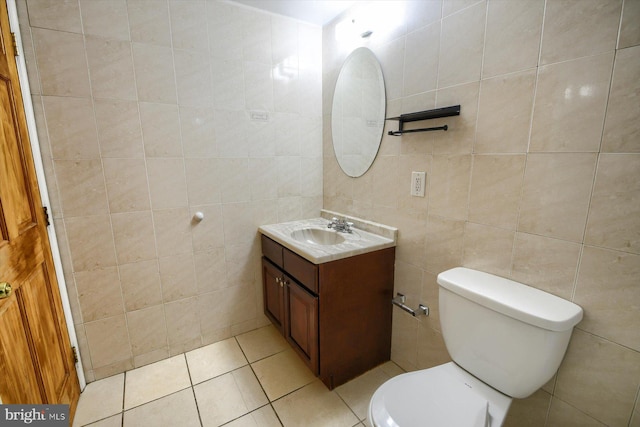 bathroom with vanity, tile walls, toilet, and tile patterned floors