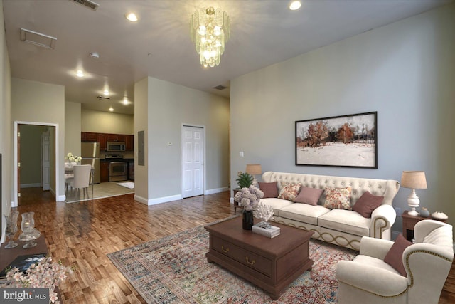 living room featuring a notable chandelier and hardwood / wood-style floors