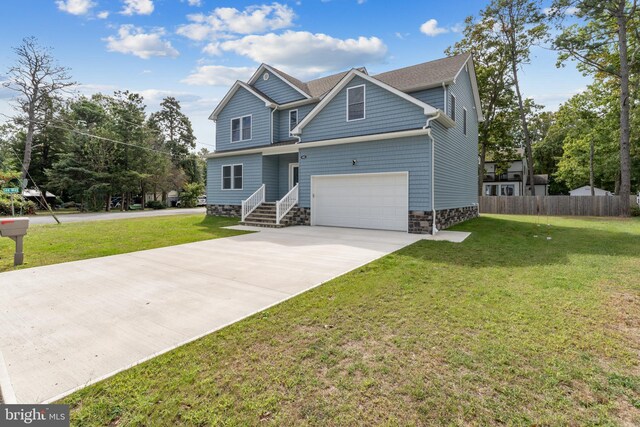 craftsman house featuring a front yard and a garage