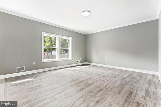 unfurnished room with light wood-type flooring and crown molding