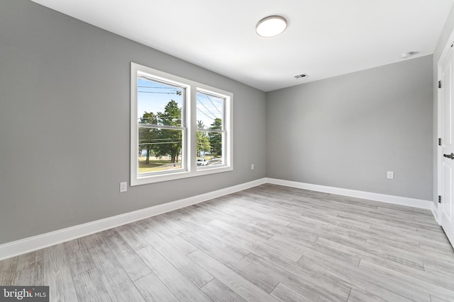 empty room with light hardwood / wood-style floors