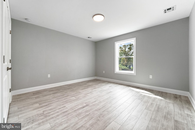 unfurnished room with light hardwood / wood-style flooring