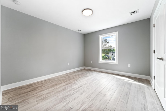 unfurnished room with light wood-type flooring