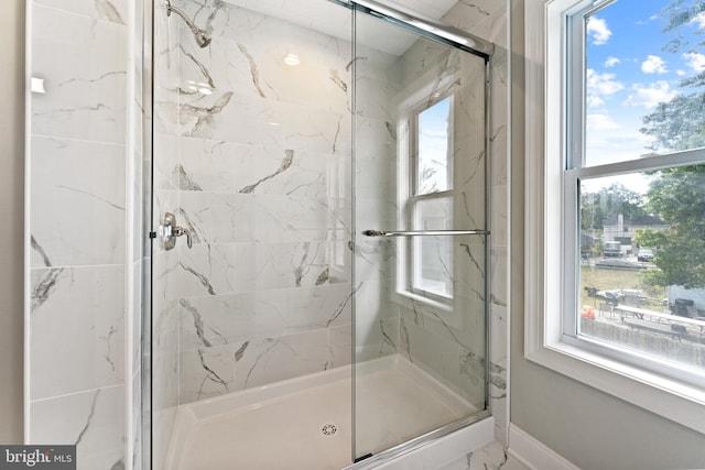 bathroom featuring plenty of natural light and an enclosed shower