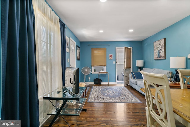 office area featuring baseboards, a fireplace, wood finished floors, and recessed lighting