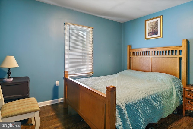 bedroom featuring dark wood-style flooring and baseboards