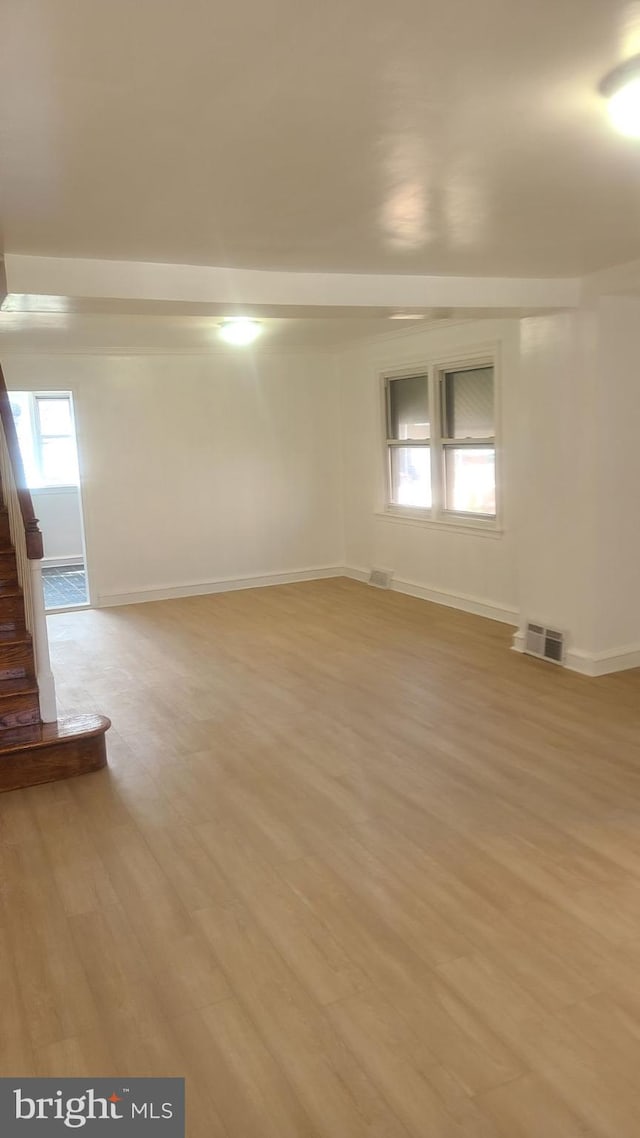 empty room with light hardwood / wood-style flooring