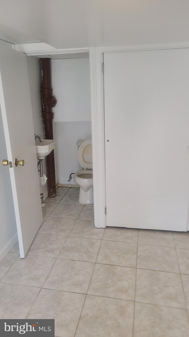 bathroom featuring sink, toilet, and tile patterned floors