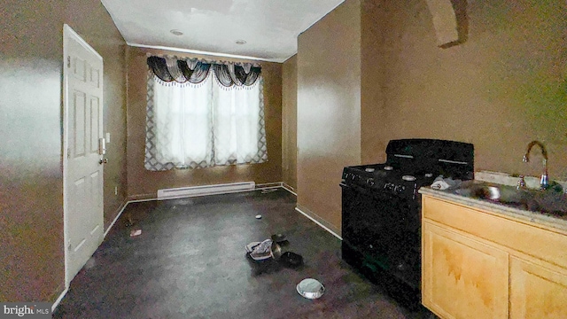 kitchen with black range with electric stovetop, light brown cabinetry, baseboard heating, and sink