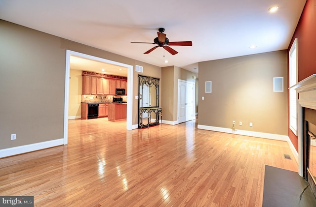 unfurnished living room featuring light hardwood / wood-style floors and ceiling fan