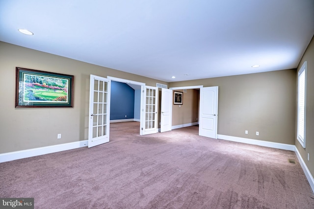 empty room featuring carpet floors and french doors