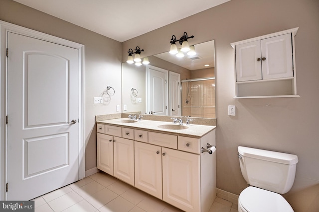 bathroom with vanity, toilet, tile patterned floors, and an enclosed shower