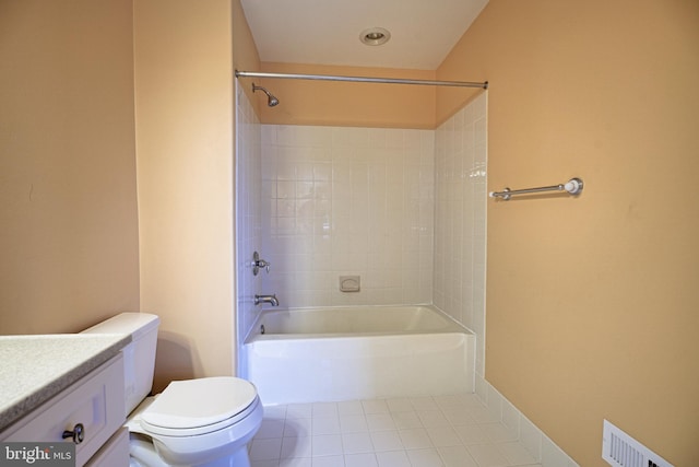 full bathroom with vanity, tiled shower / bath combo, toilet, and tile patterned flooring