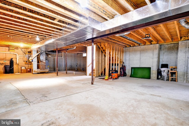 basement with heating unit and electric panel