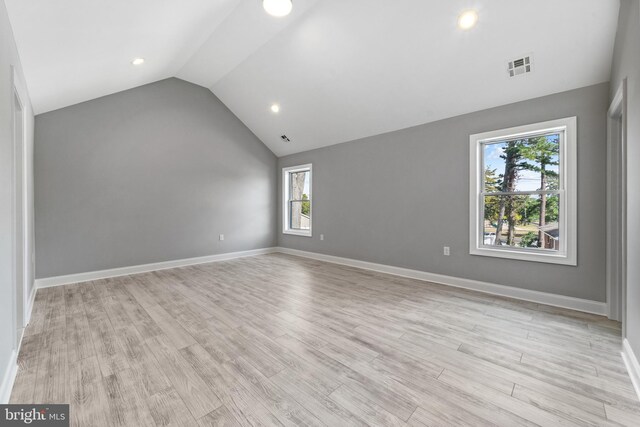 1406 Circle Dr, Forked River, NJ 08731 - unfurnished room featuring light wood-style flooring, baseboards, vaulted ceiling, and visible vents
