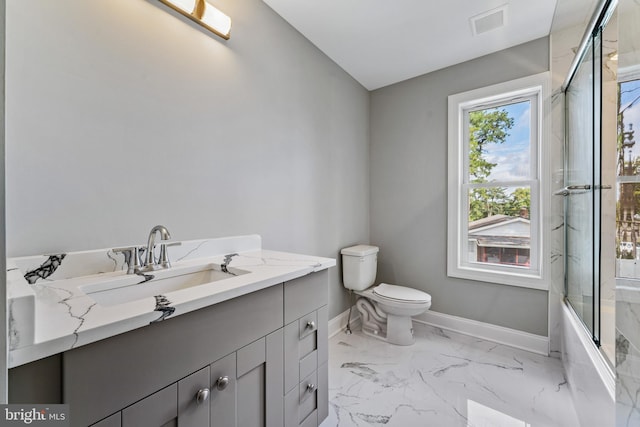 full bathroom featuring shower / bath combination with glass door, vanity, and toilet