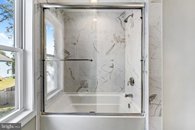 bathroom featuring a healthy amount of sunlight and enclosed tub / shower combo