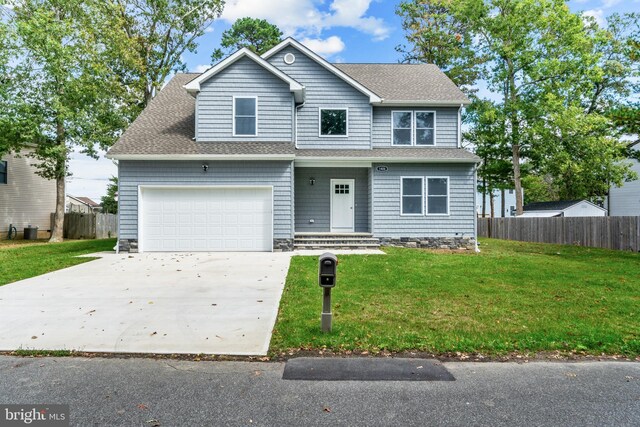 1406 Circle Dr, Forked River, NJ 08731 - view of front of house with roof with shingles, concrete driveway, a front yard, and fence